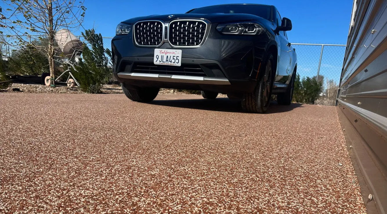 Car driving on resin bound driveway.